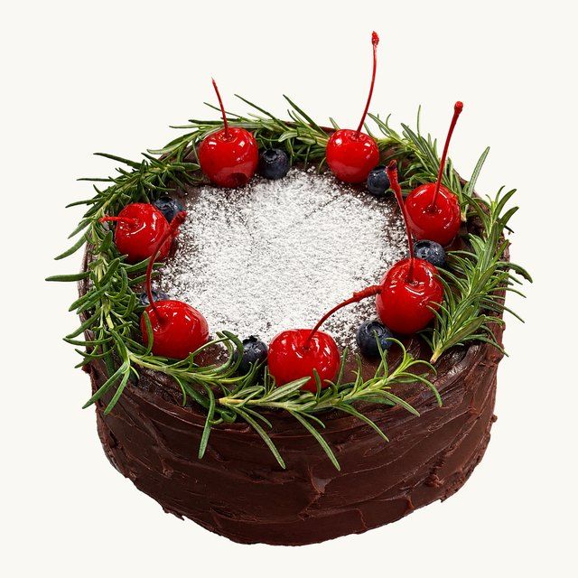 Matilda Cake with a cocoa-dusted top, cherries and rosemary