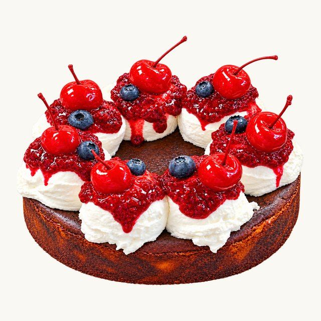 Pistachio Raspberry Basque Cheesecake topped with whipped cream, raspberry jam and cherries