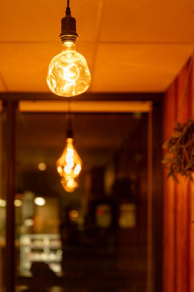 Pendant lights over a wood table at CozyHaus