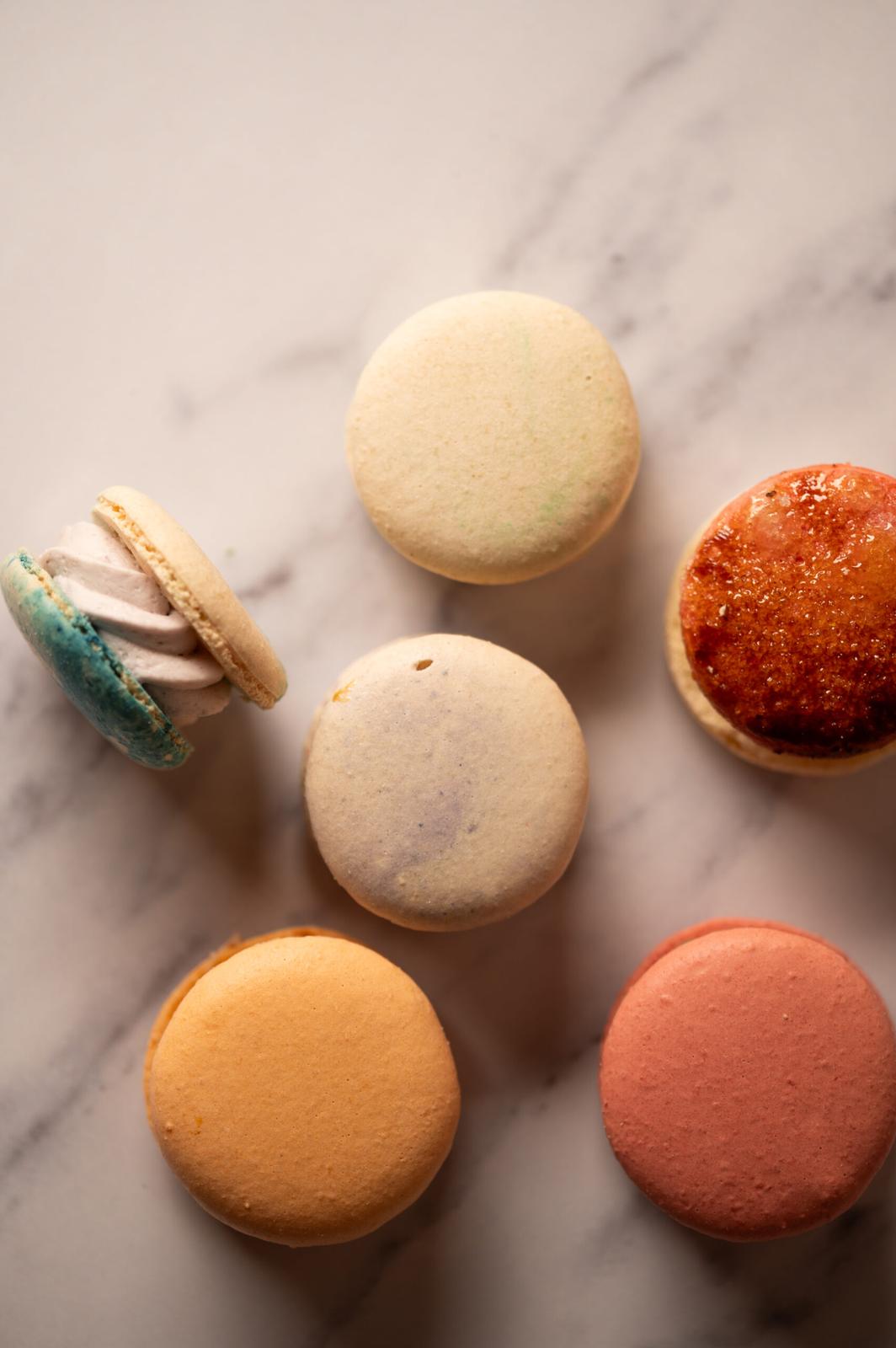 Five macaron flavours on marble
